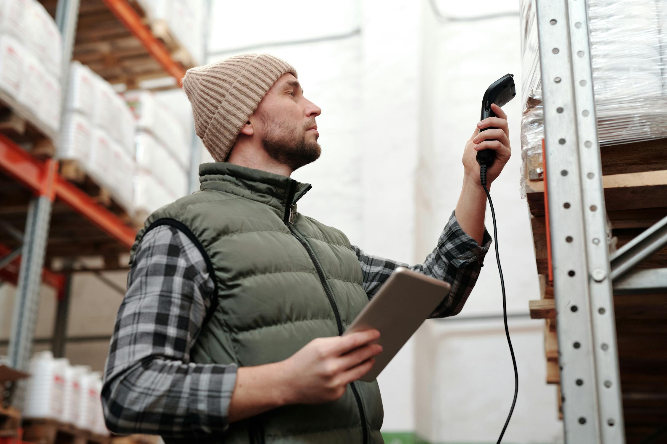 Warehouse worker scanning inventory labels with a handheld device